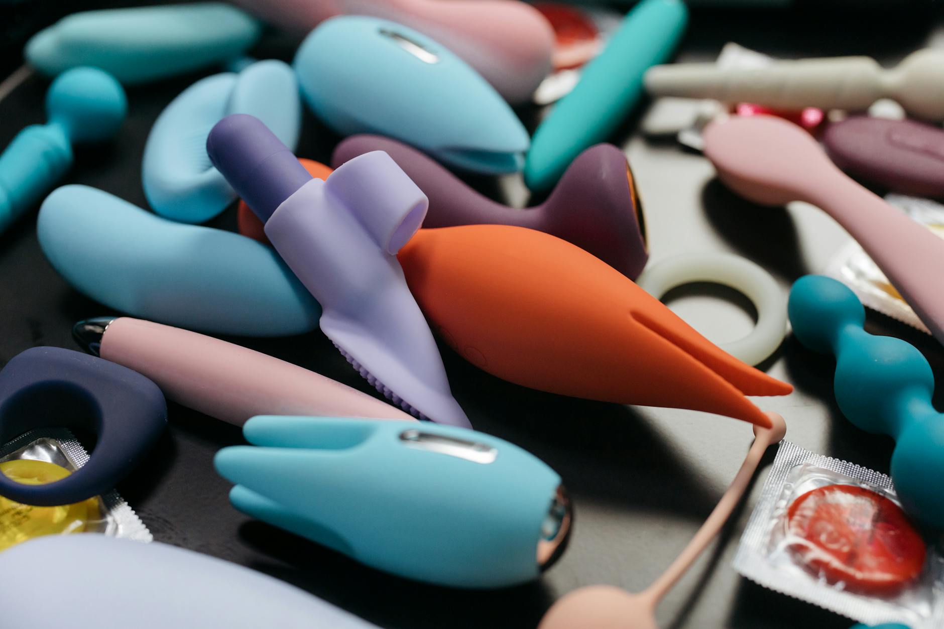 Close-up of hands holding a sleek blue vibrator, symbolizing intimate pleasure during medication adjustment